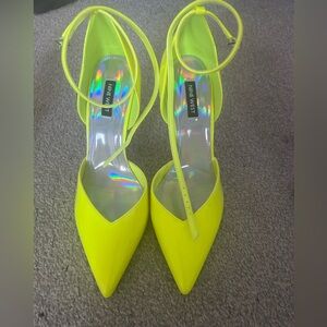 Neon yellow ankle strap patent pumps.